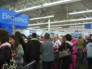 Black Friday shoppers wait in a long check out line at a Wal-Mart store.