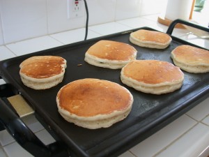 Cooking up pancakes on a stove top griddle.